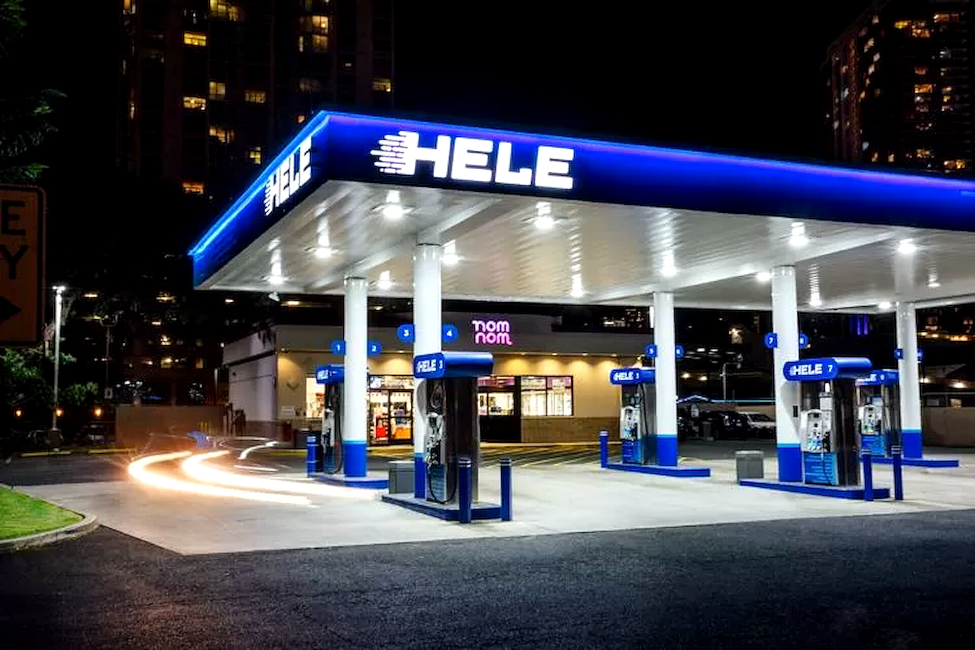Hele gas station and nomnom convenience store at night with blue LED canopy lighting